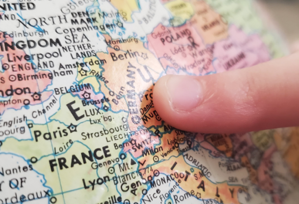 maps1_cropped Image of a finger pointing on Germany on a globe.